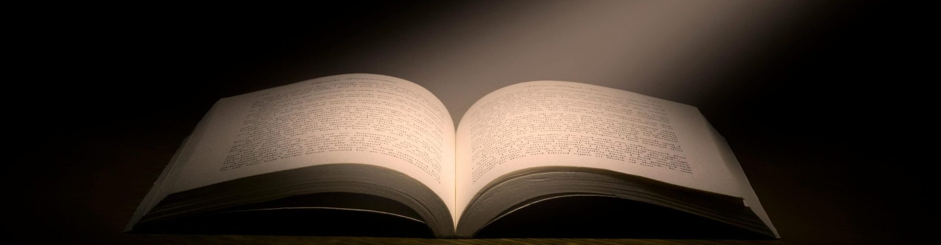A captivating image of an open book under a dramatic spotlight, symbolizing knowledge.